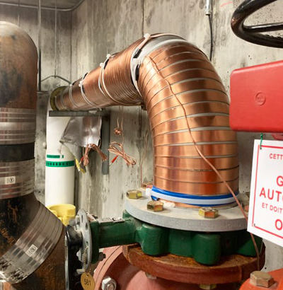 Vulcan descaler on curved water pipe